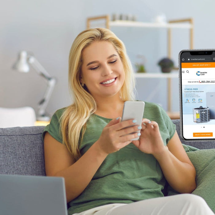 A woman sitting on a sofa buys an A/C system on InverterCool website on her mobile phone.